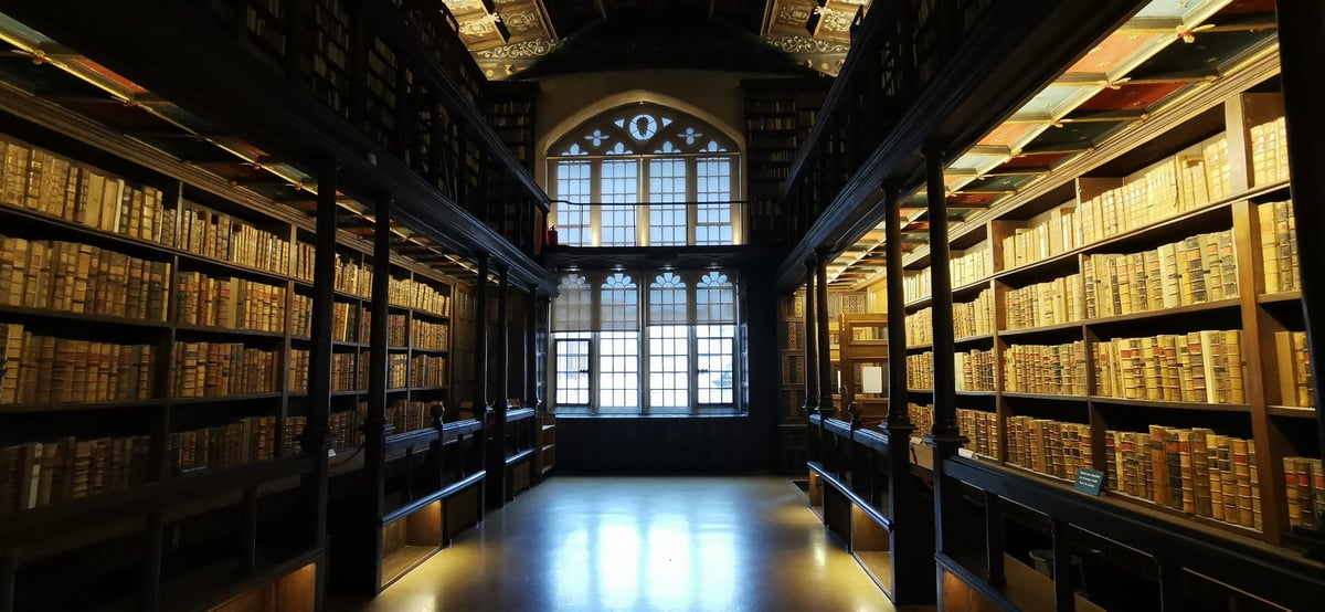 Ancient books on the shelves of the Old Bodleian Library at Oxford University