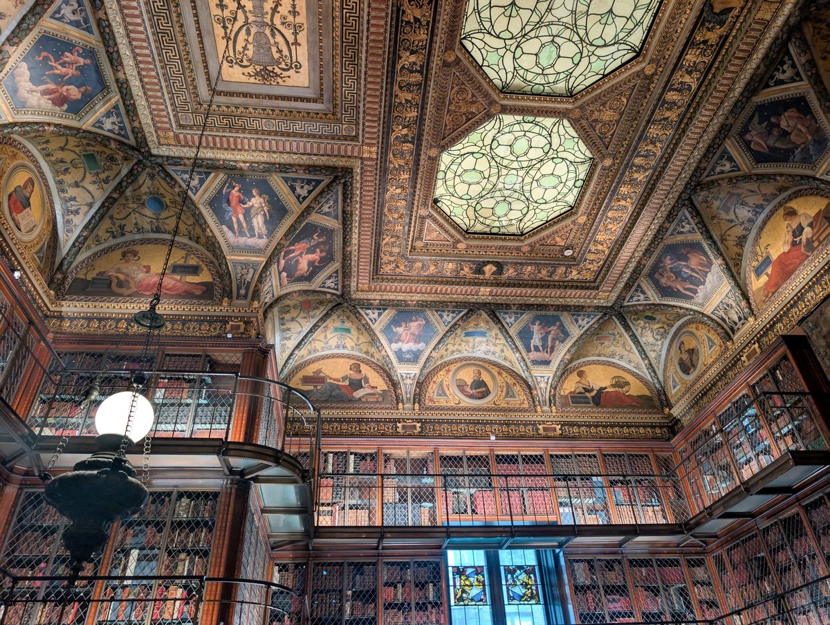 The Morgan Library — bookshelves and ceiling with warm scholarly light